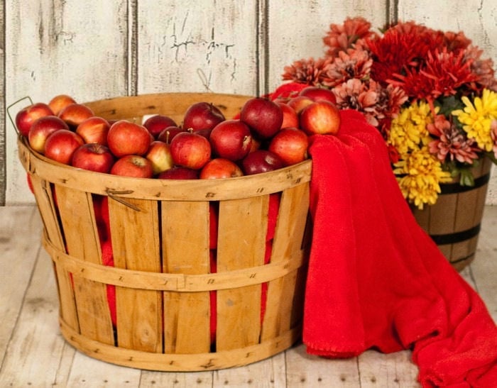 Basket of red apples sitting on porch