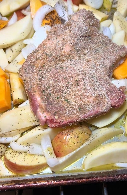Pork chops and potatoes on a sheet pan for dinner