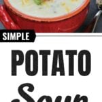 Red bowl filled with creamy potato soup topped with bacon, shredded cheese, and green onions, placed beside a spoon on a dark background.