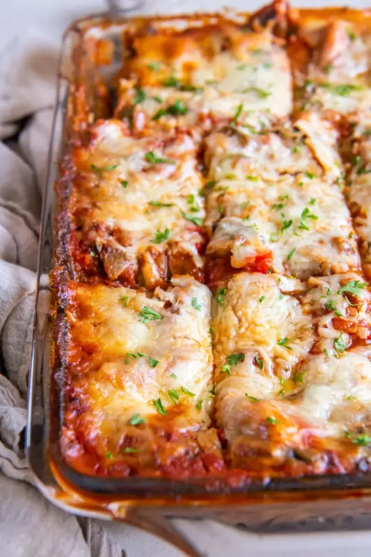A cheesy, veggie-packed lasagna with layers of tomato sauce, ricotta, and baked goodness.