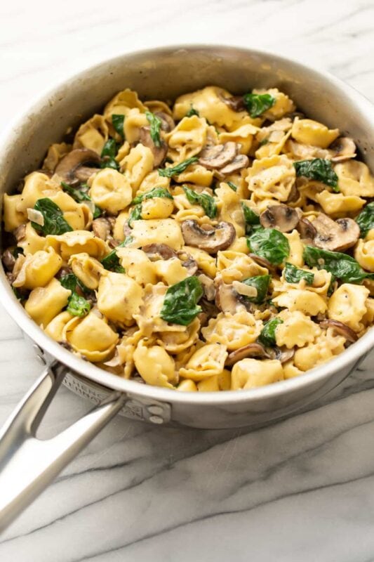 A rich and creamy tortellini dish with mushrooms, spinach, and a velvety sauce.