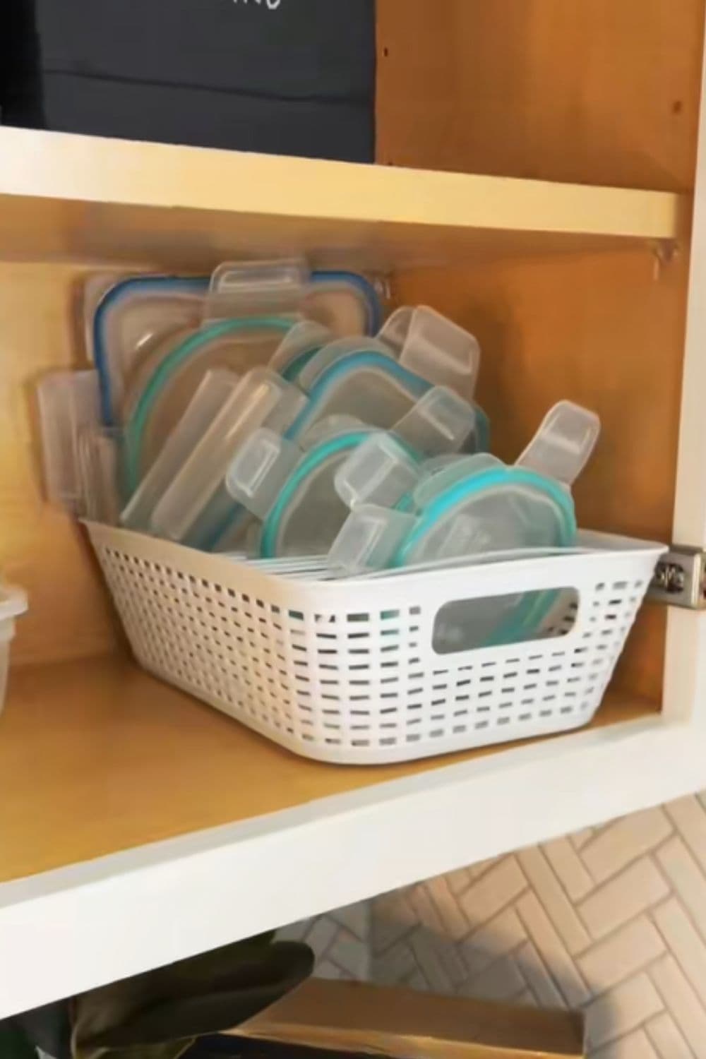 Pot lids stored upright in a dish rack inside a cabinet, a practical dollar store hack for keeping lids organized and easy to grab.