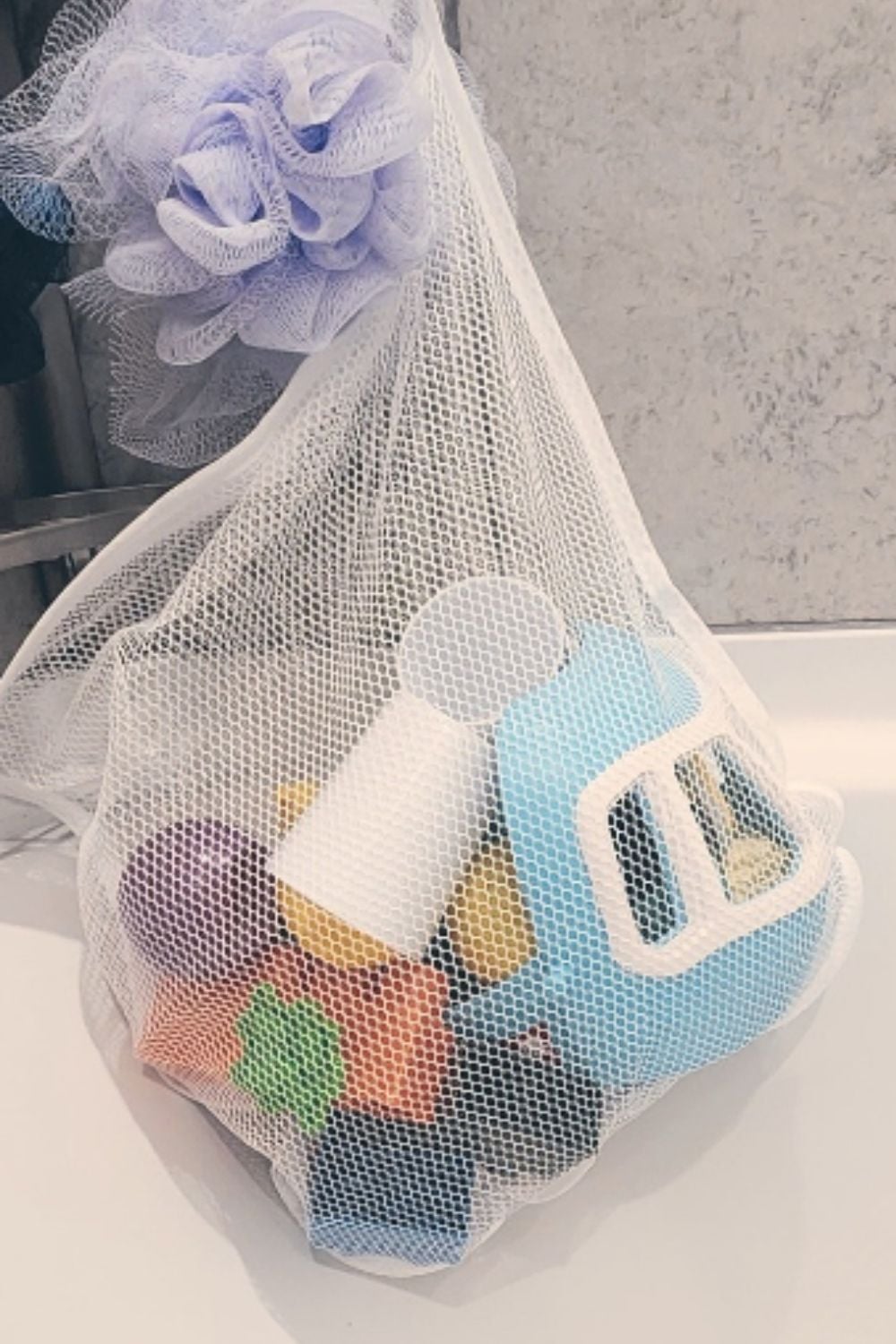 Mesh laundry bag holding bath toys, one of those simple dollar store hacks that lets toys dry properly and keeps bath time cleanup easy.