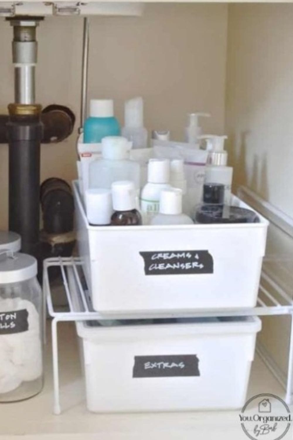 Plastic bins organizing toiletries under the sink, an easy dollar store hack that keeps everything visible and easy to grab.