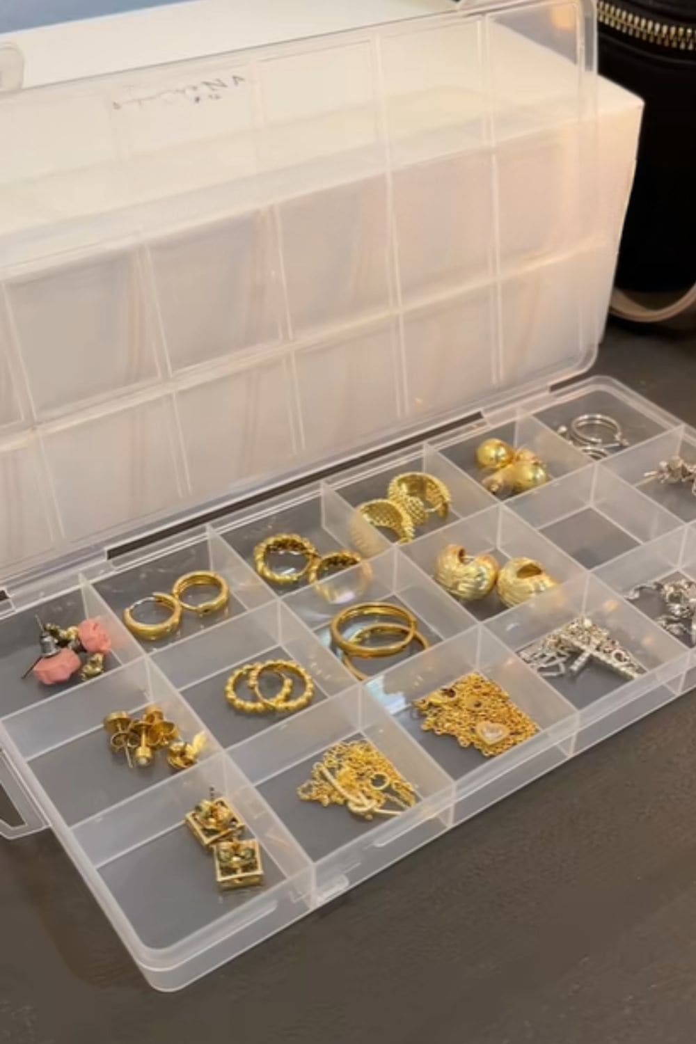 Pill organizer holding earrings, a clever dollar store hack for keeping jewelry sorted without tangles or missing pieces.