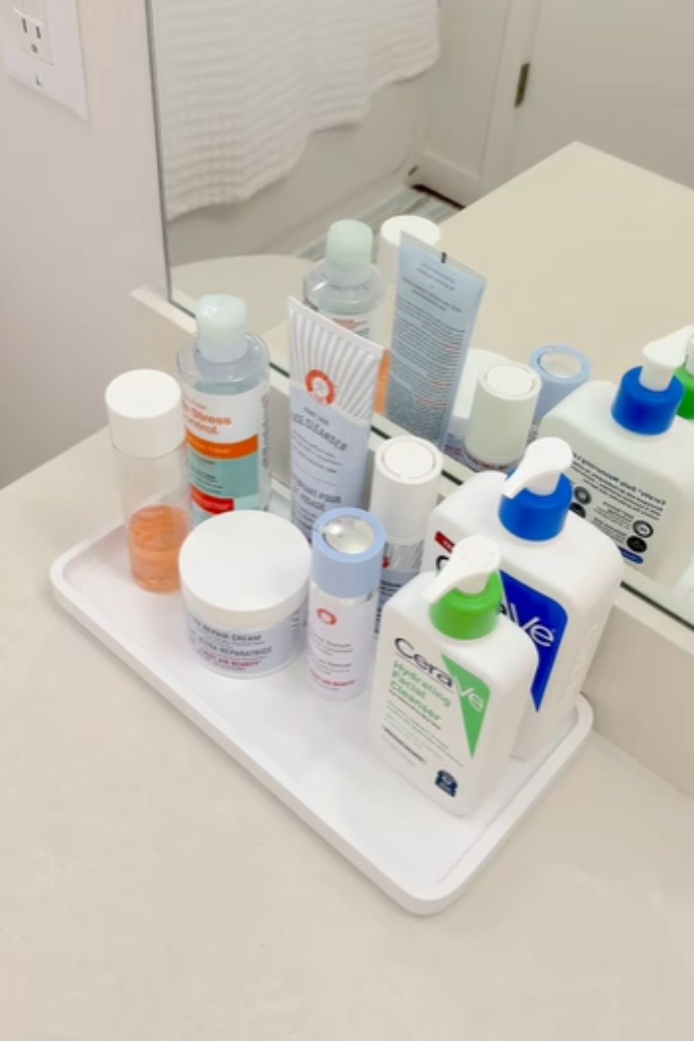 Bathroom counter styled with a plastic tray, a simple dollar store hack that keeps daily essentials from spreading everywhere.