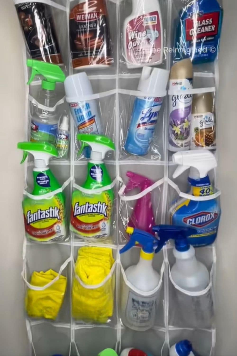 Over-the-door shoe organizer filled with cleaning supplies, a smart dollar store hack for creating extra storage without taking up cabinet space.