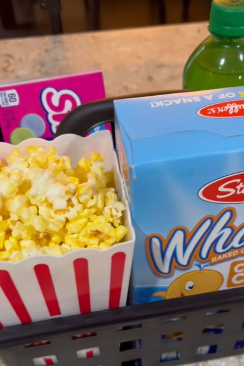 Snack bins creating easy grab-and-go snack zones, a simple dollar store hack that helps kids find snacks and keeps the pantry organized.