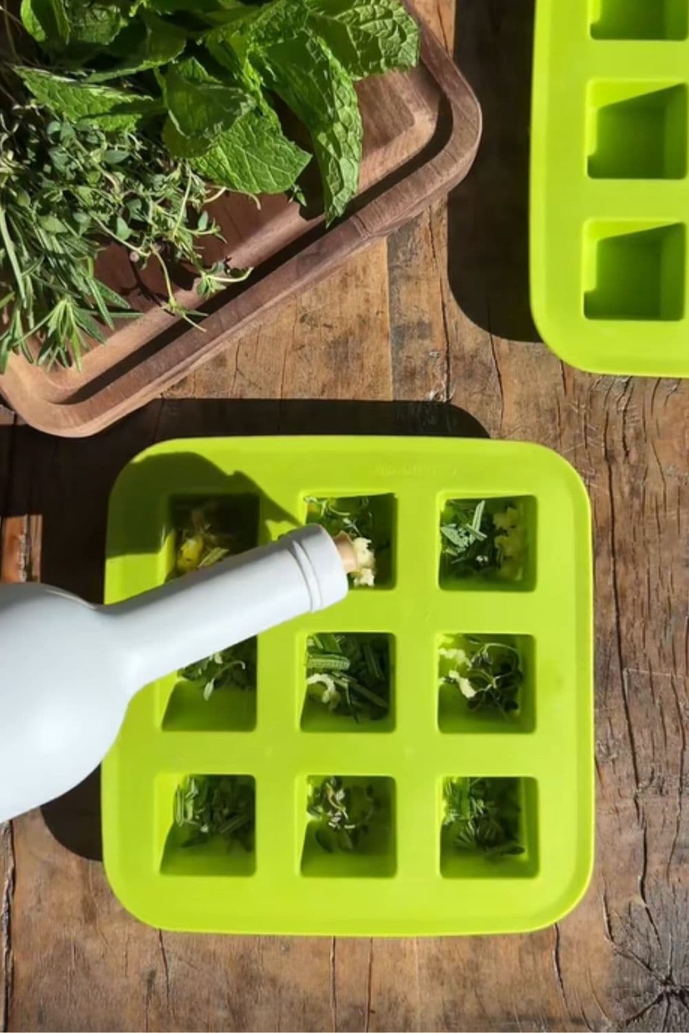 Fresh herbs frozen in ice cube trays, a smart dollar store hack for saving herbs, reducing waste, and adding flavor to meals fast.