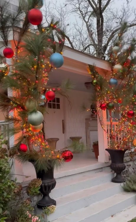 Cut limbs in buckets with lights and Christmas Balls
