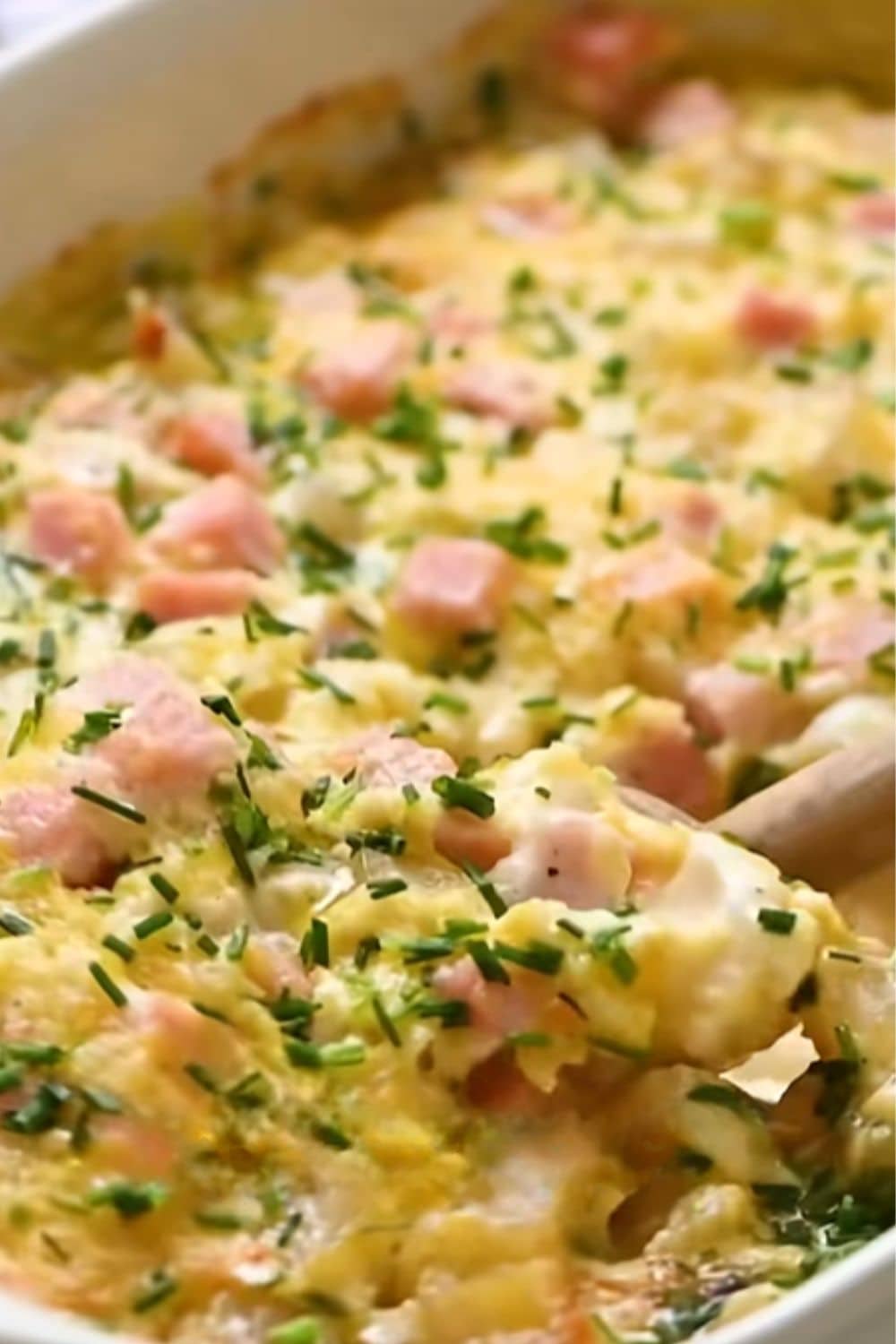 Tender potatoes and diced ham covered in creamy sauce and melted cheese, one of those cozy dump and bake recipes everyone loves.