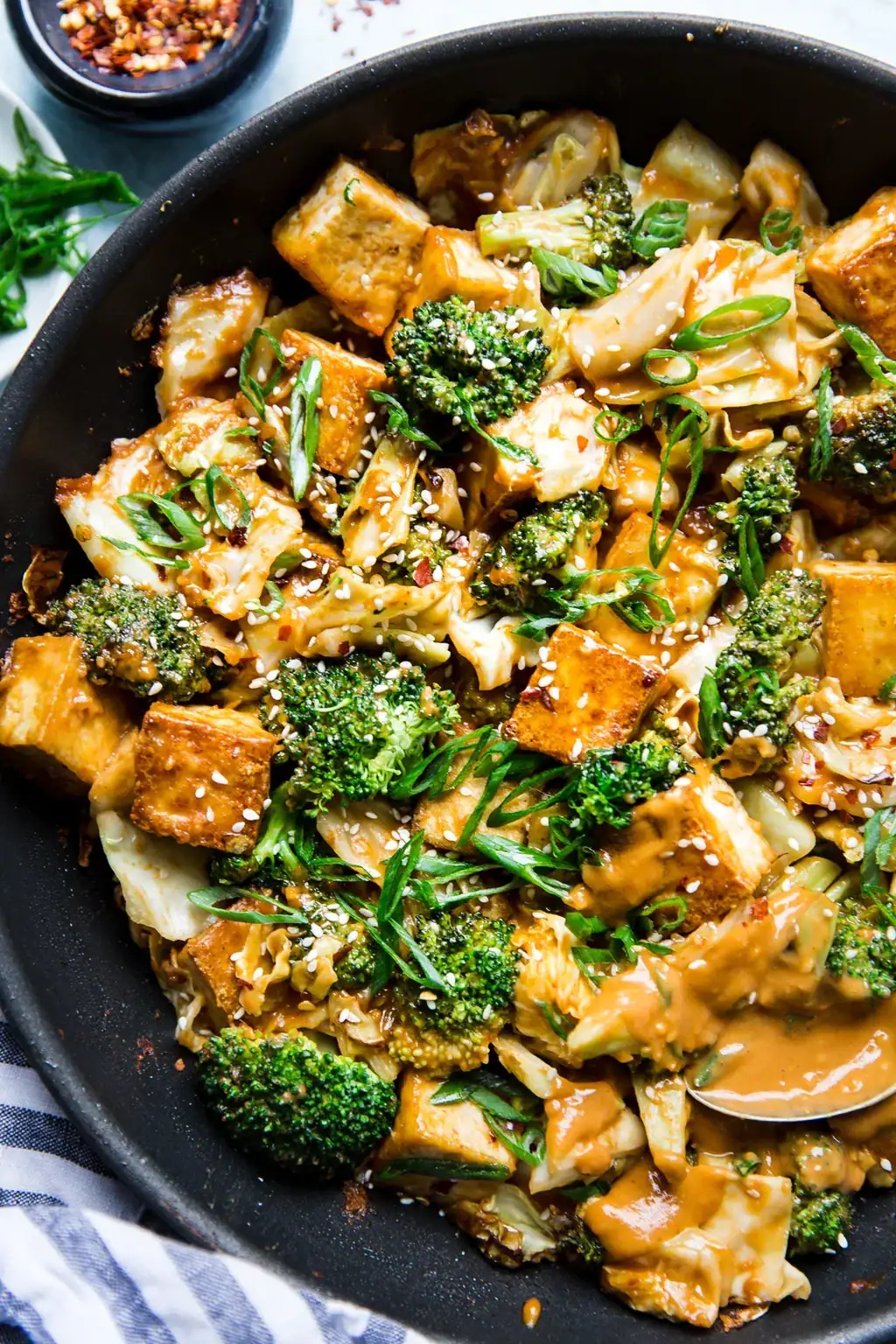 Tofu stir-fry with peanut sauce and vegetables, a plant-based high protein meal