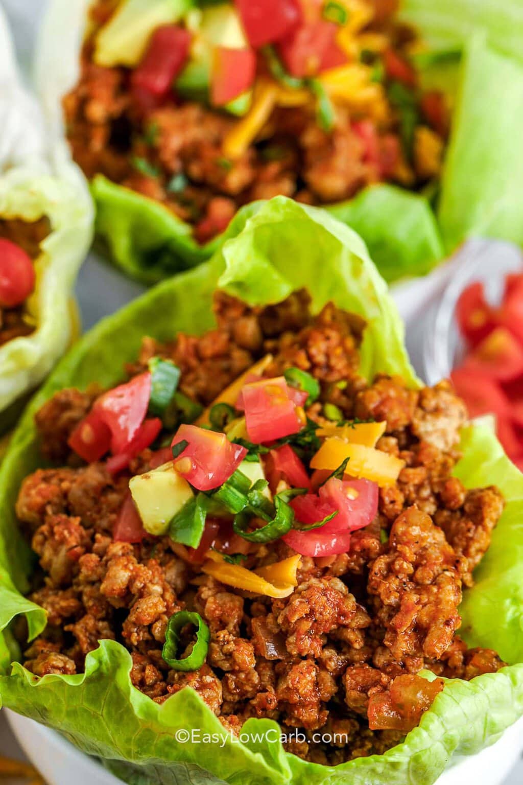 Beef taco lettuce wraps filled with seasoned meat and toppings, a low calorie high protein dinner